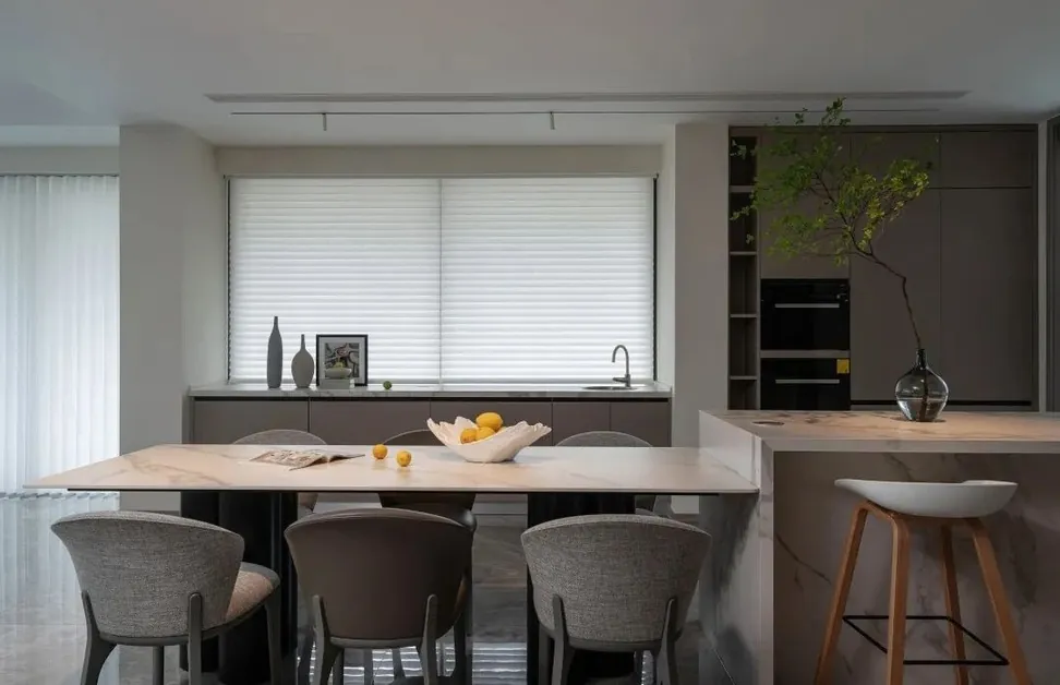 Modern custom kitchen with quartz waterfall island and integrated appliances, Oahu showroom