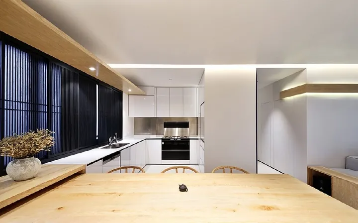 Handleless modern kitchen featuring slab-front cabinetry and under-cabinet LED lighting, Oahu custom installation
