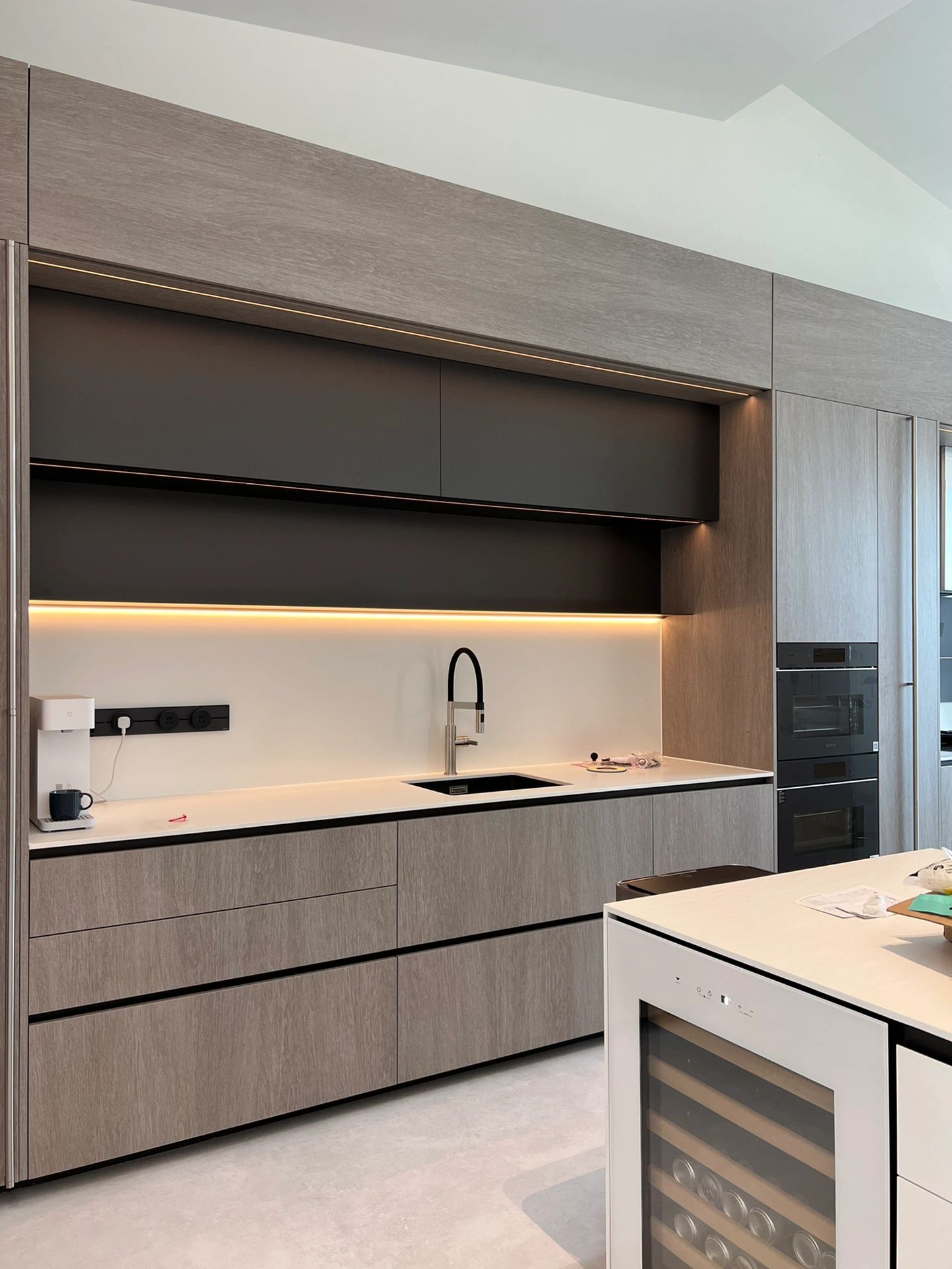 Grey oak handleless kitchen with LED accents — Kaka'ako, O'ahu