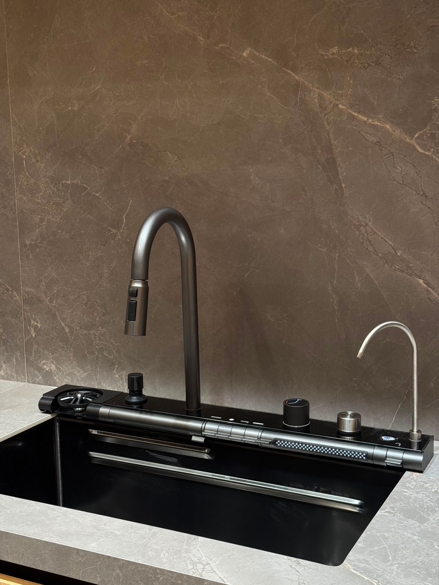 Black granite composite kitchen sink with pull-down faucet, filtered water tap, and integrated touch controls — Ward Design Center showroom