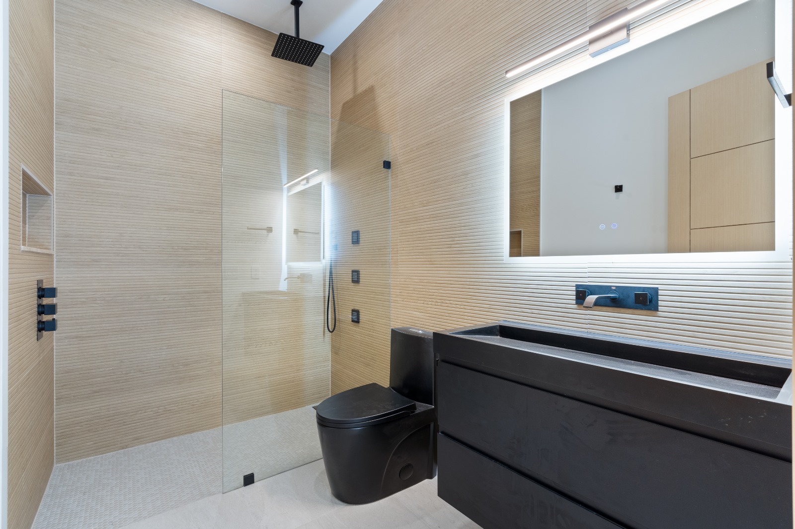 Spa bathroom with oak wood-look tile, black vanity and rain shower — O'ahu