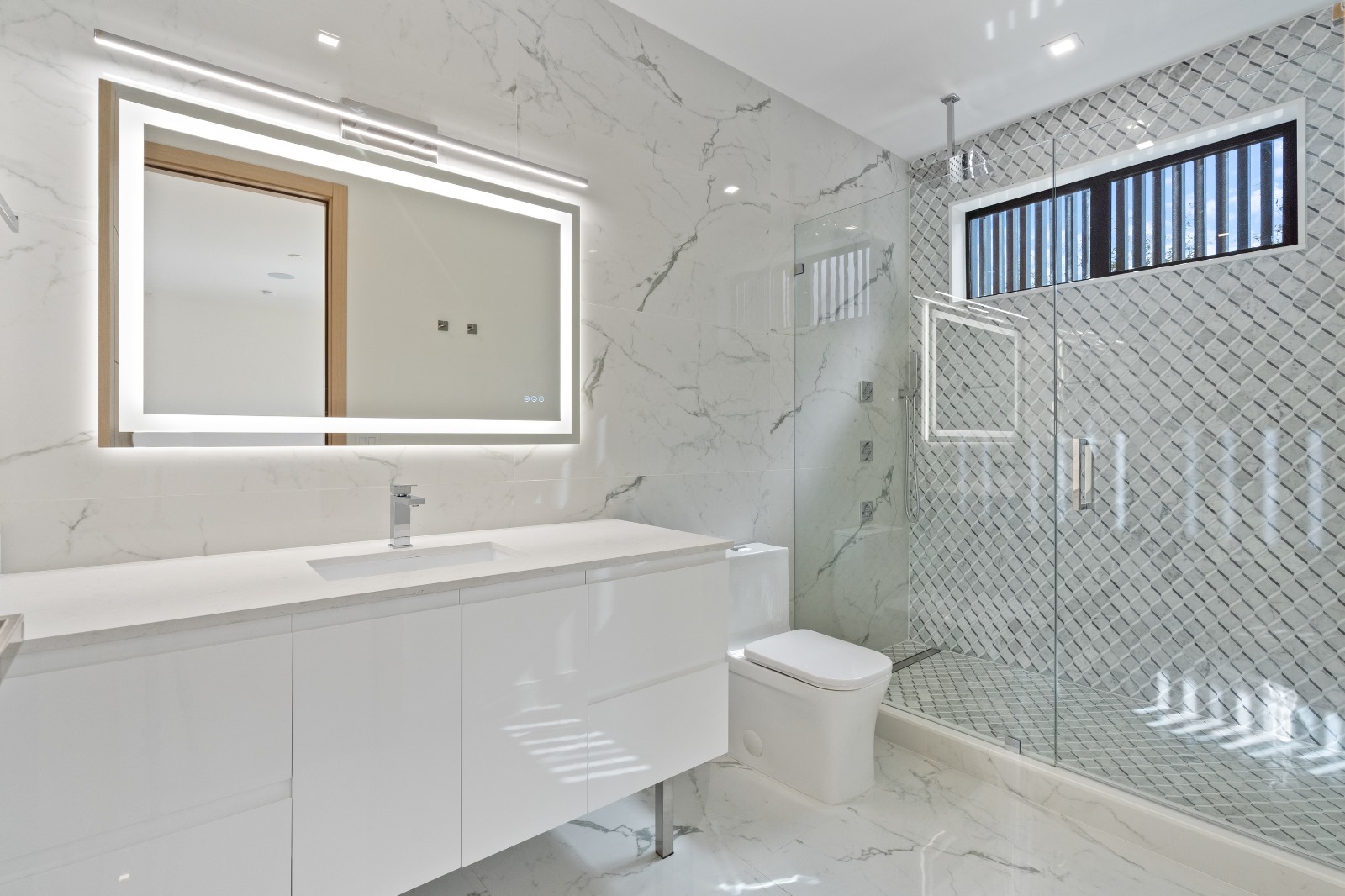 Marble bathroom with LED mirror, diamond mosaic shower and floating vanity — O'ahu
