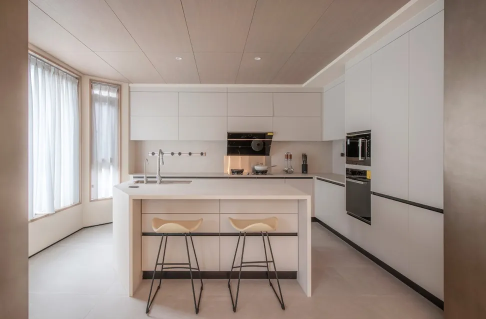 Minimalist kitchen design with porcelain countertops and tall storage walls, Hawaii residence