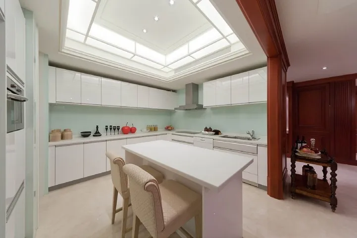 Custom kitchen cabinets featuring walnut accents and soft-close drawers, Oahu custom installation