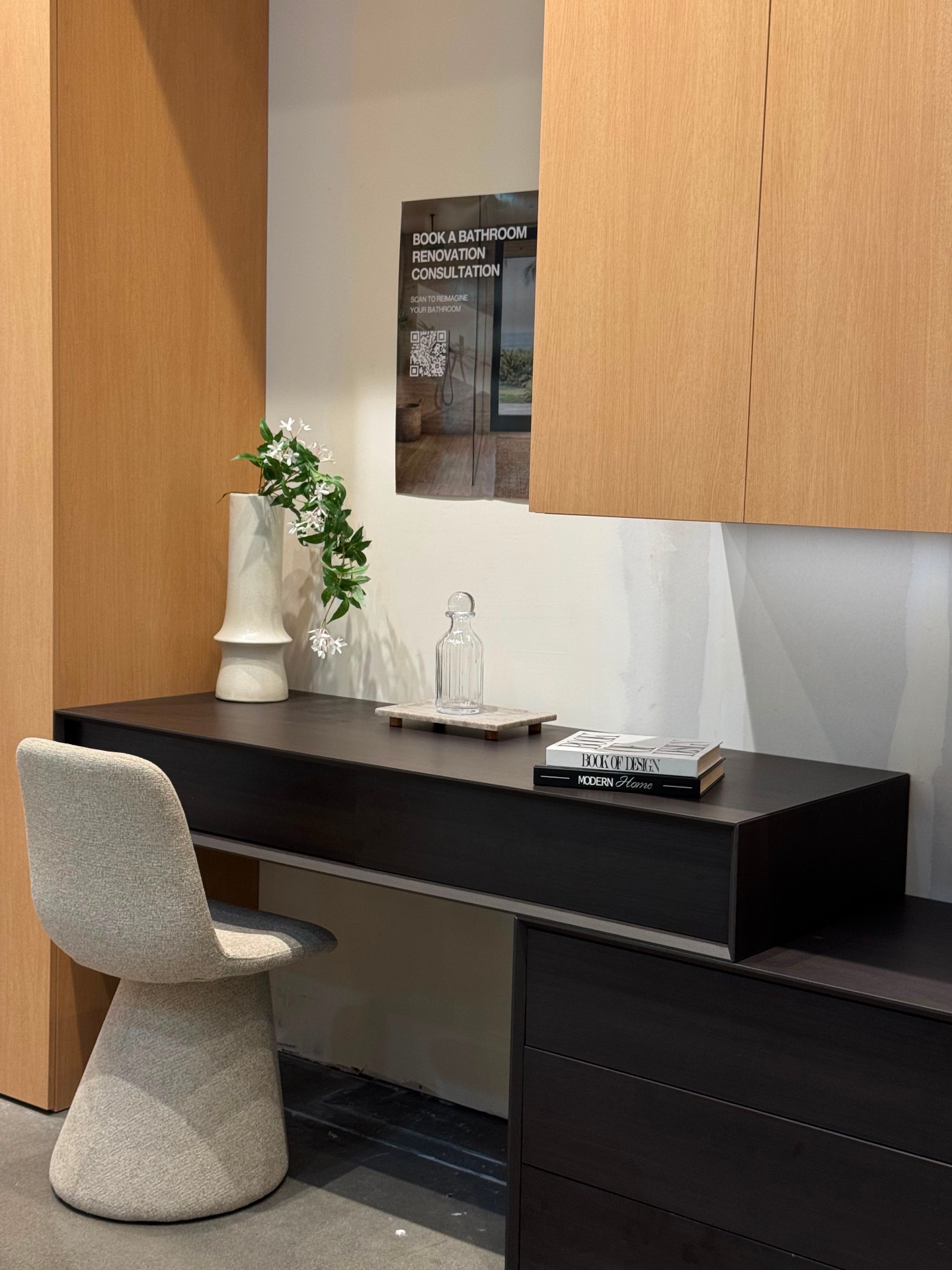 Espresso oak floating vanity desk with upholstered chair, displayed at Ward Design Center showroom in Kapolei, Hawaii