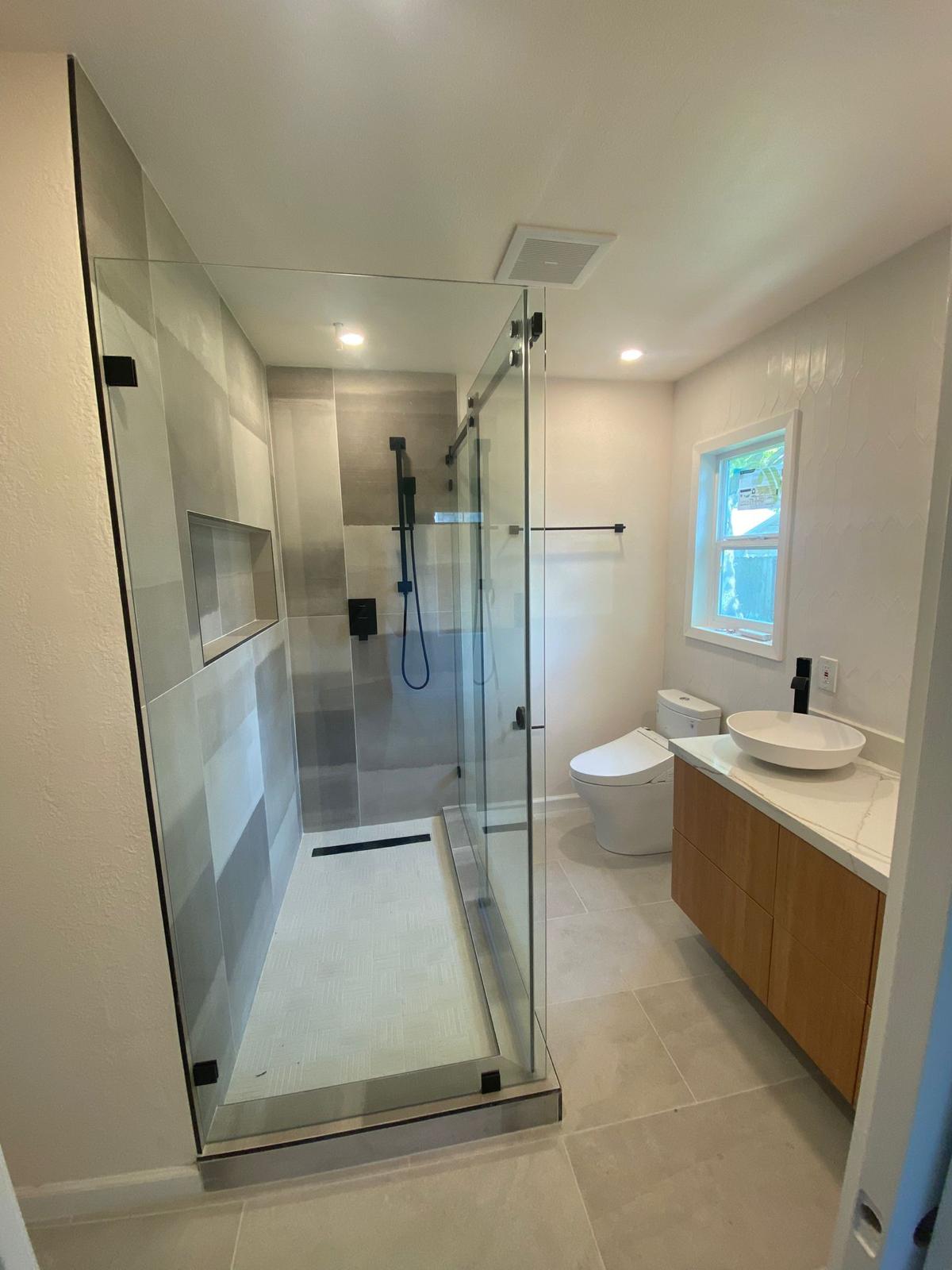 Guest bath with frameless glass shower, oak floating vanity and vessel sink — O'ahu
