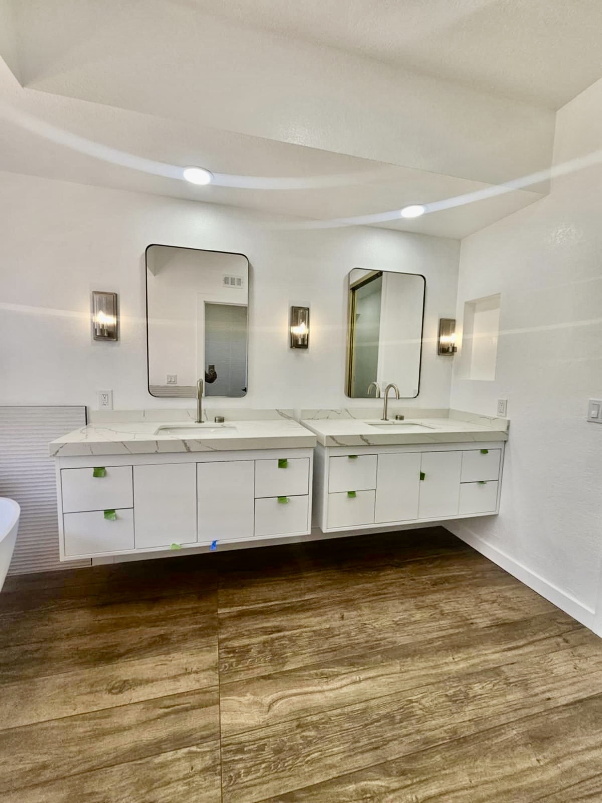 Double floating vanities with marble waterfall counters — O'ahu