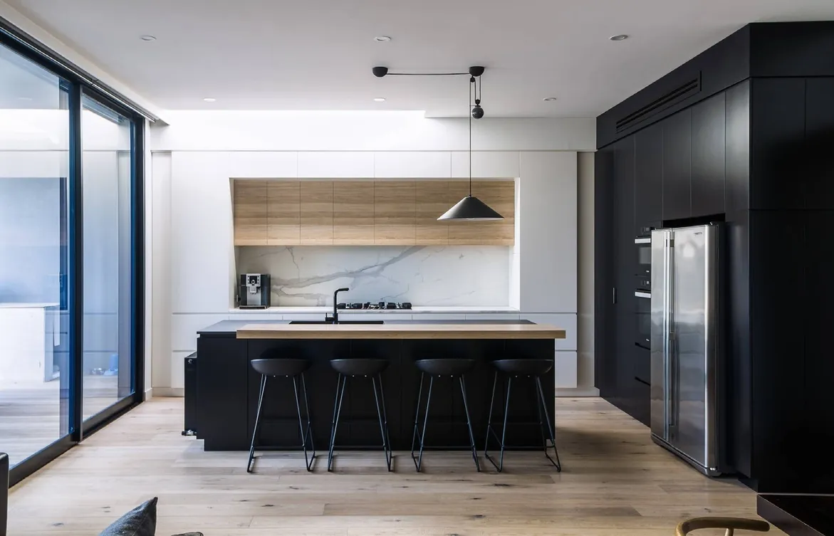 Minimalist kitchen design with porcelain countertops and tall storage walls, Hawaii residence
