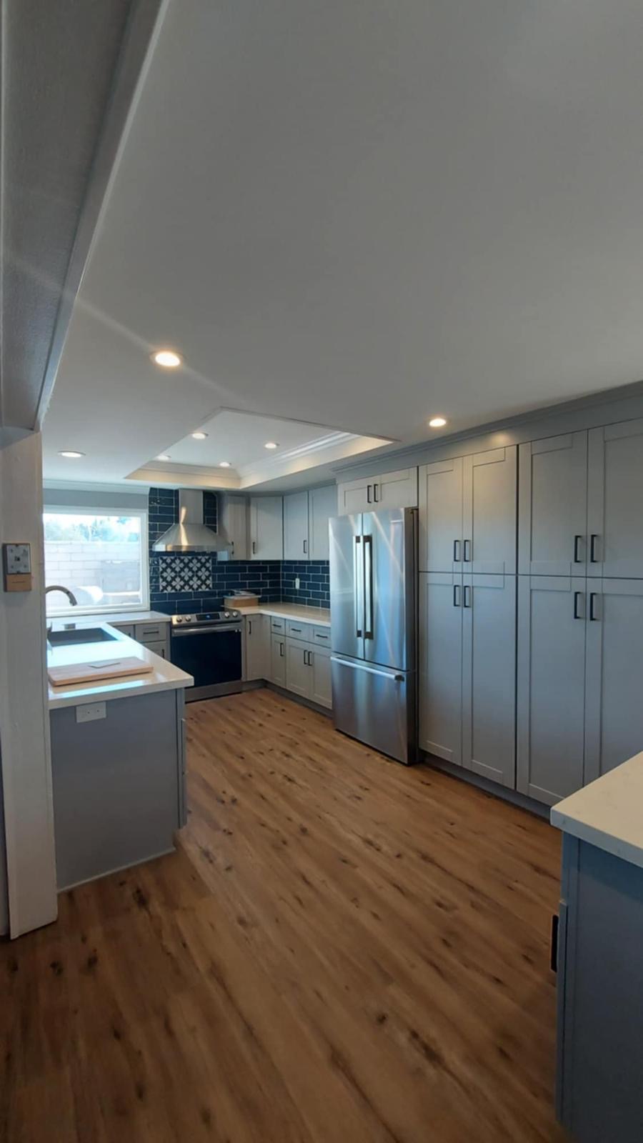 Grey shaker kitchen with navy subway backsplash — O'ahu