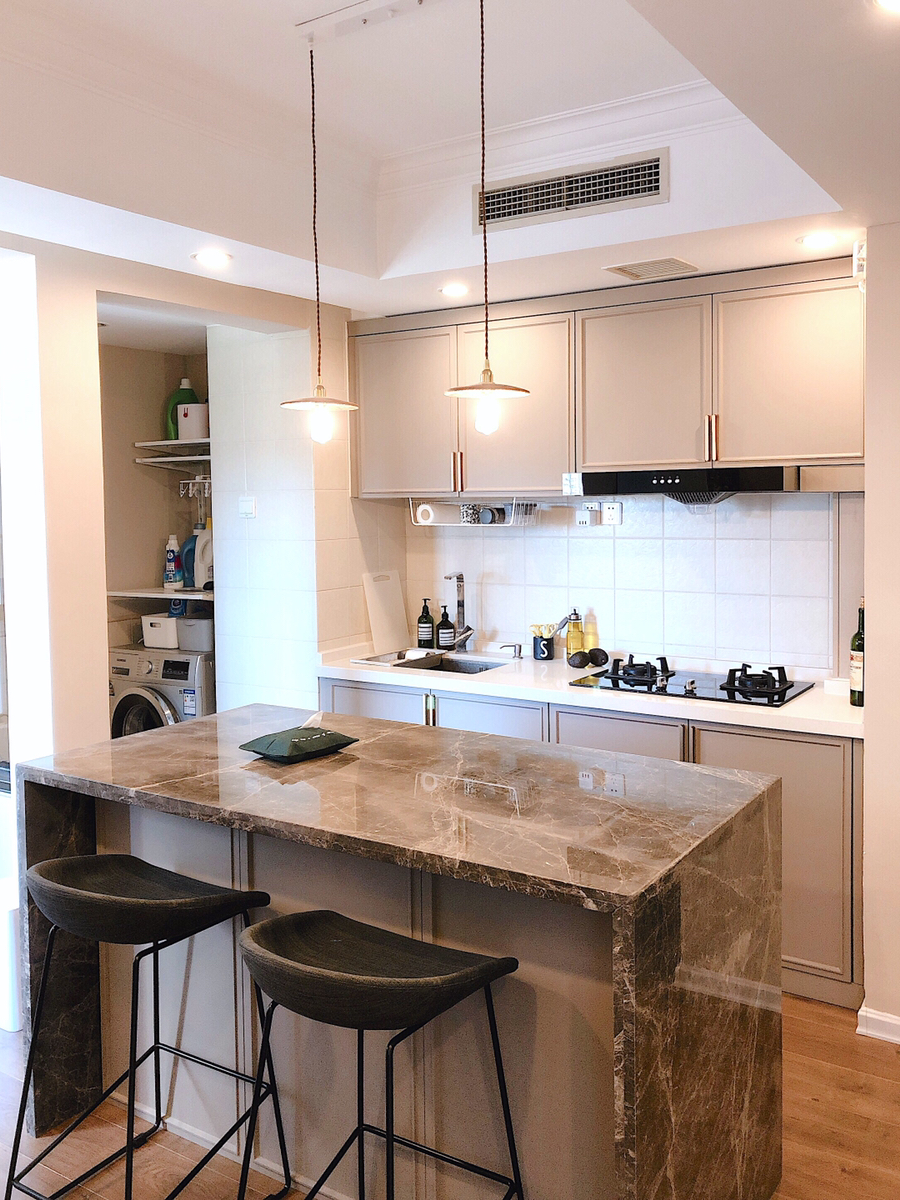 Transitional kitchen with marble waterfall island — Honolulu, O'ahu