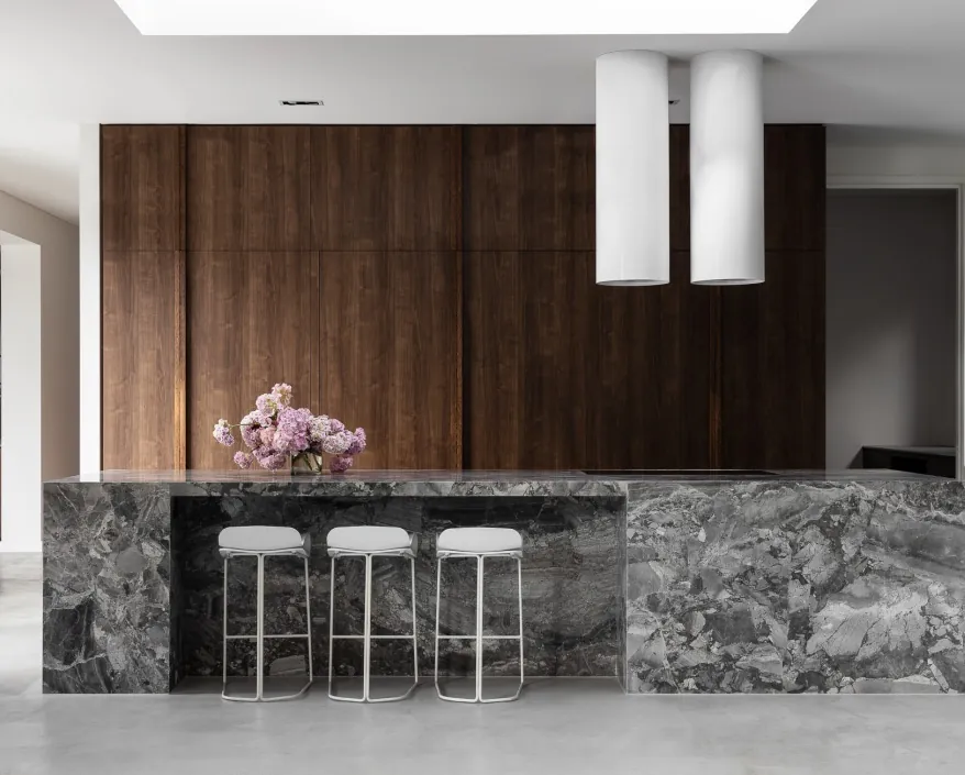 Modern custom kitchen with quartz waterfall island and integrated appliances, Oahu showroom